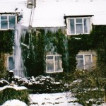The cottage the winter before it was sold. The huge icicle cascading from the roof was caused by a permanently running overflow!