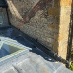 Cast iron downpipe added to prevent flooding on flat roof